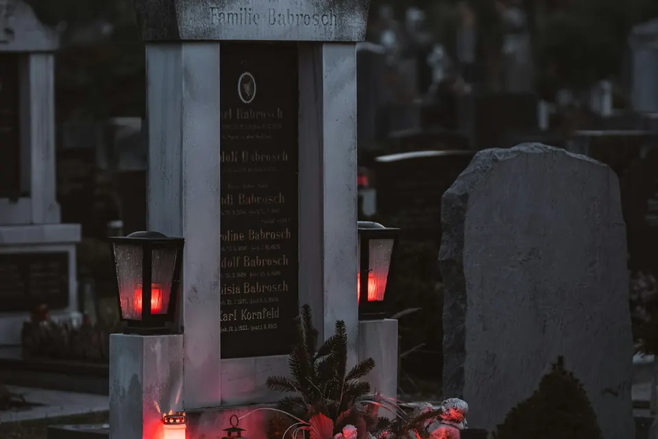 Kapinės prieblandoje su degančiomis žvakėmis